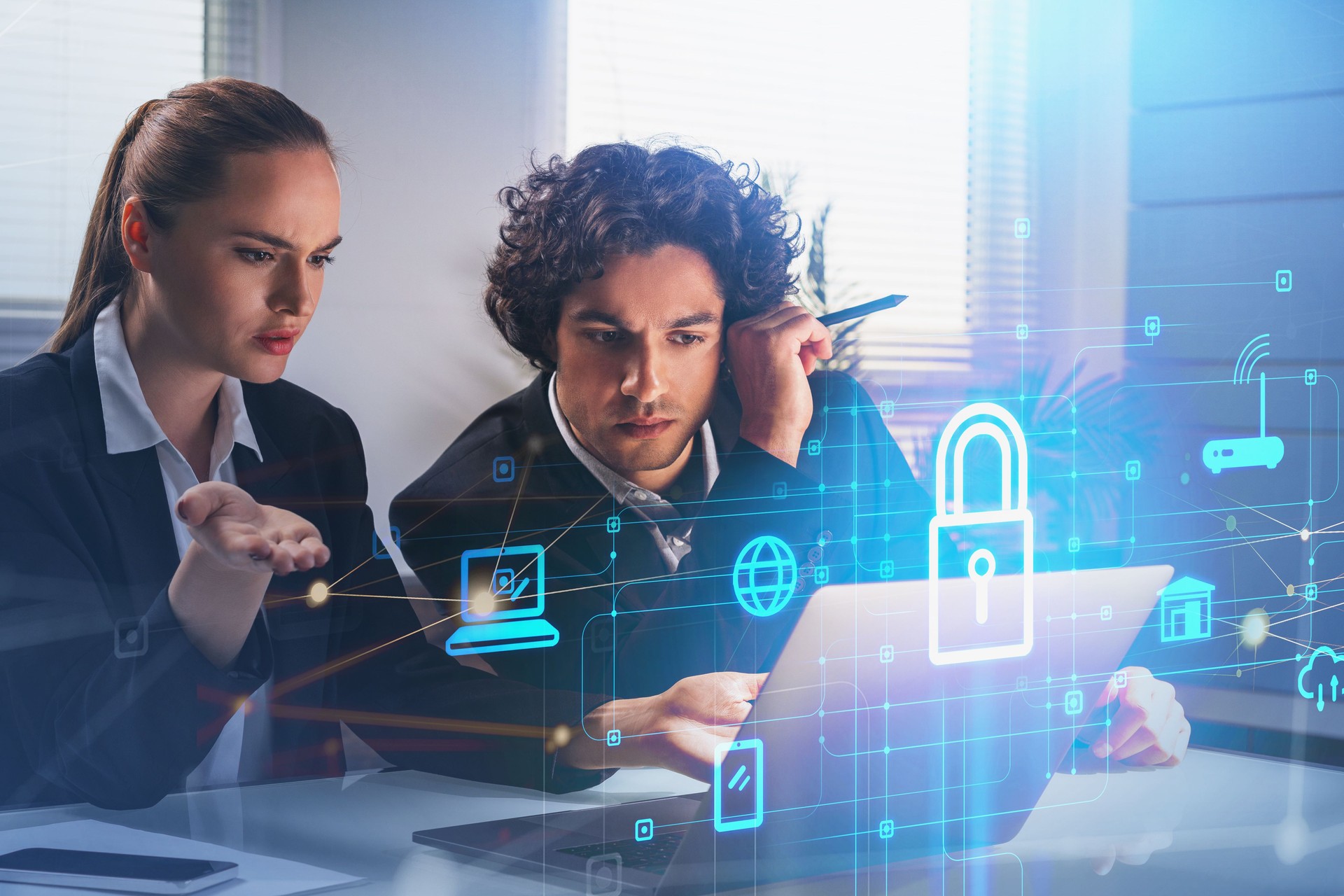 Two thoughtful business people with laptop, desktop at office in